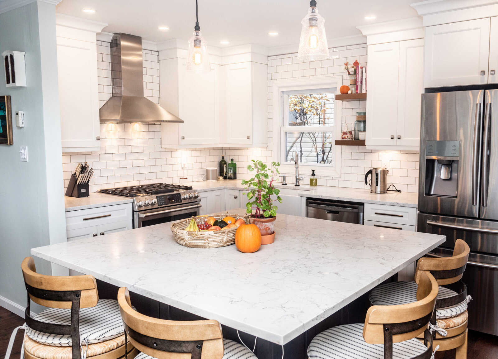 Kitchen island facing a range and custom hood