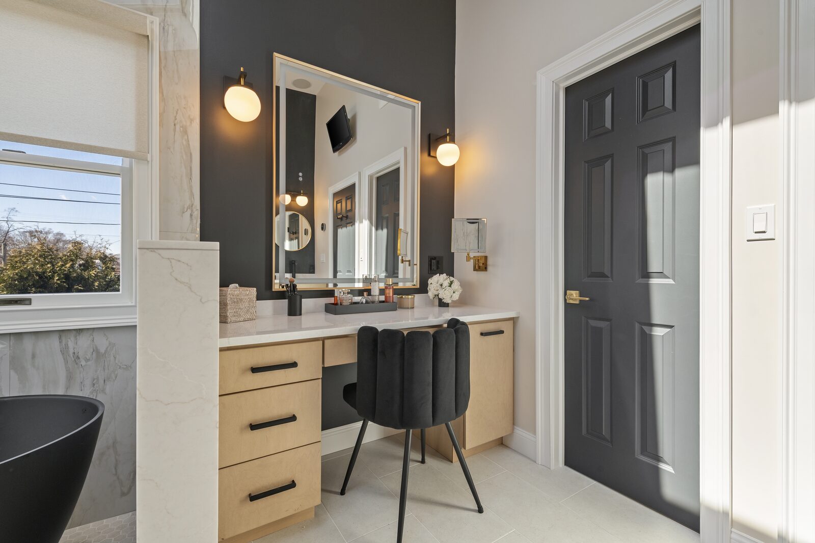 Light wood makeup vanity with a dark accent wall