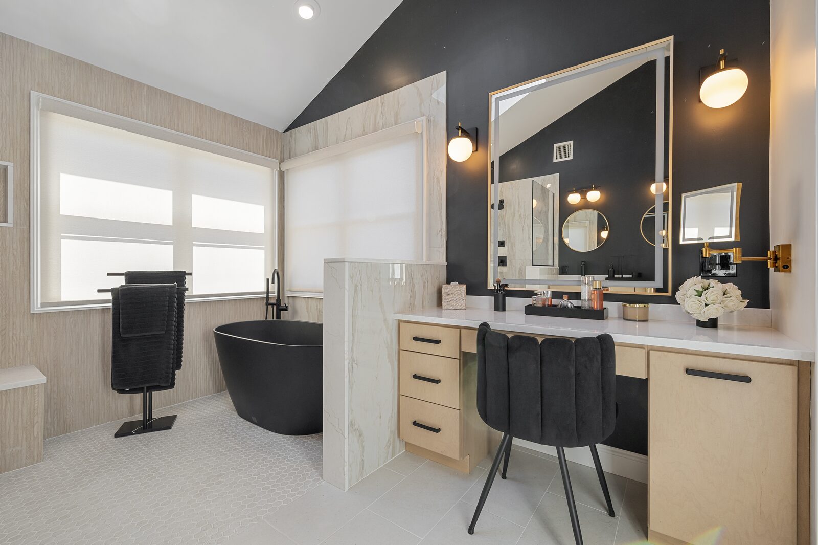 Wide view of a vanity and freestanding bathtub