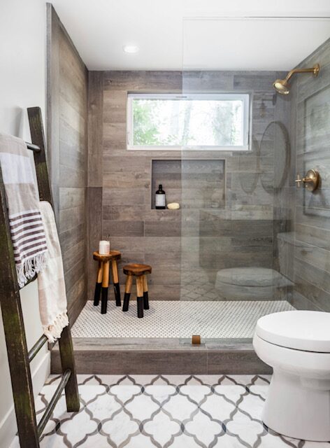 Gray tile walk-in shower with glass enclosure