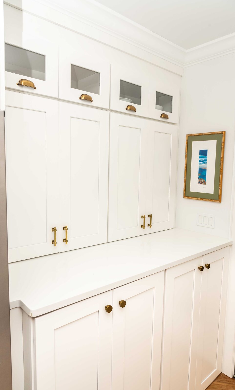 Tall white storage cabinets in a laundry room