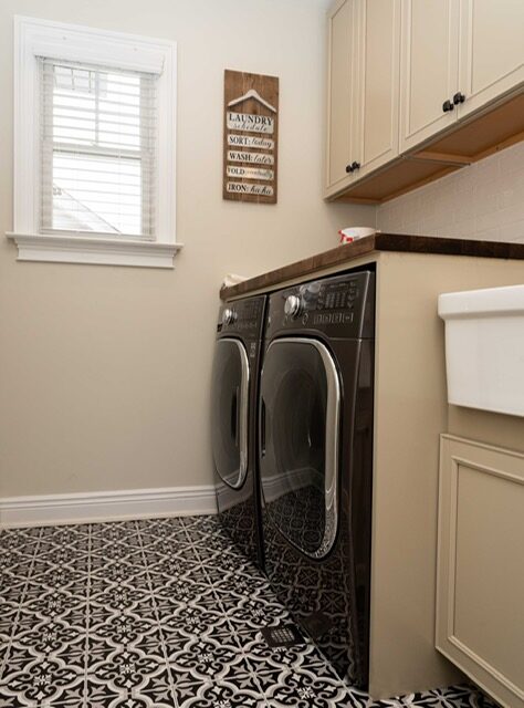 Washer and dryer beside a utility sink