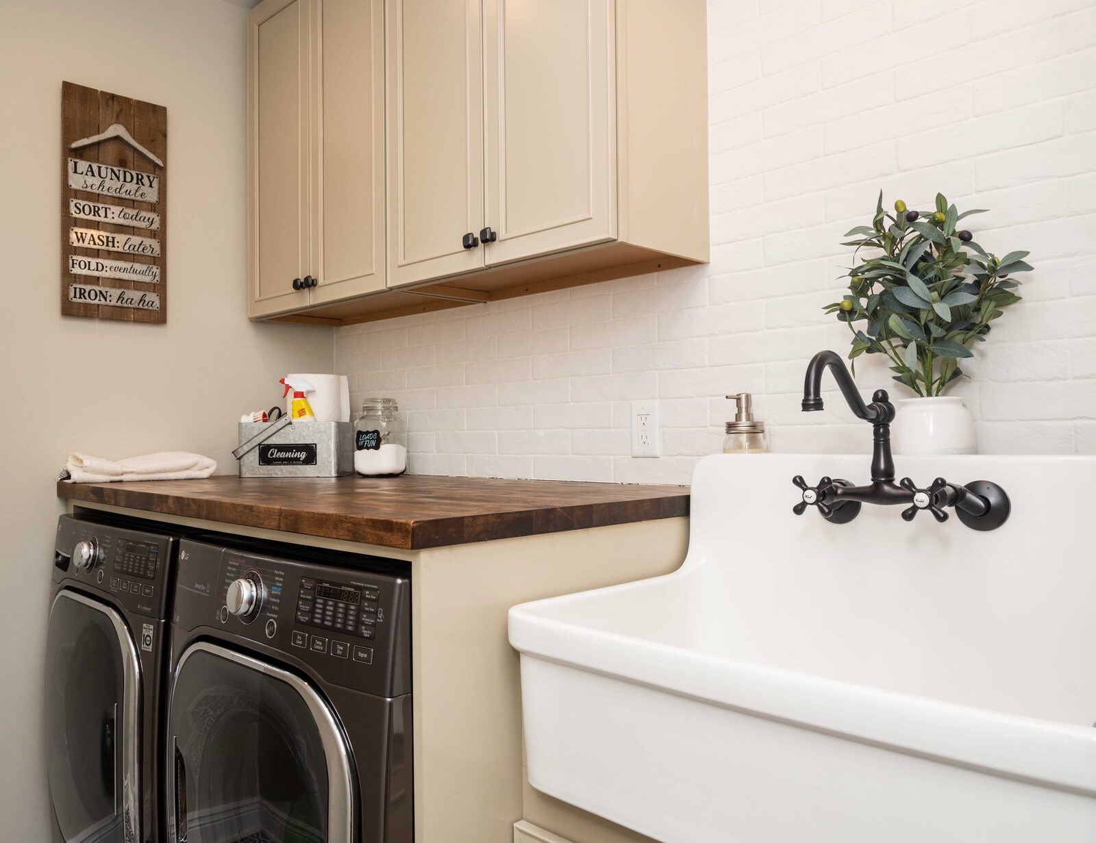 Laundry room with wall cabinets and a utility sink